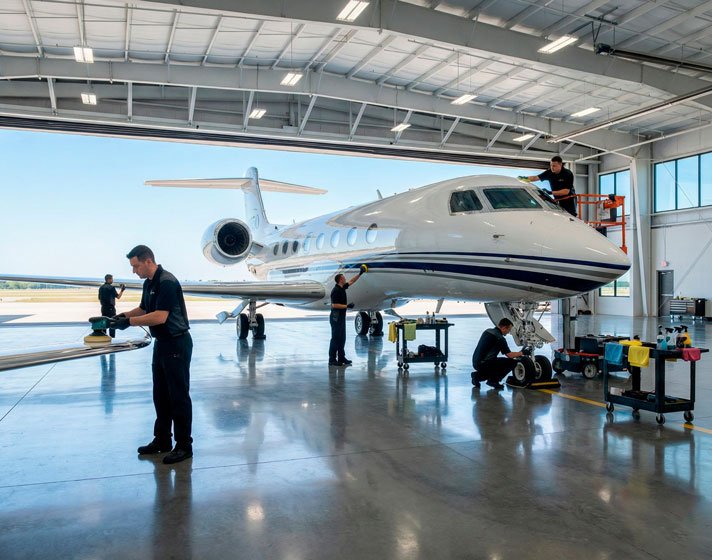 Mobile aircraft detailing technicians cleaning a private jet on-site